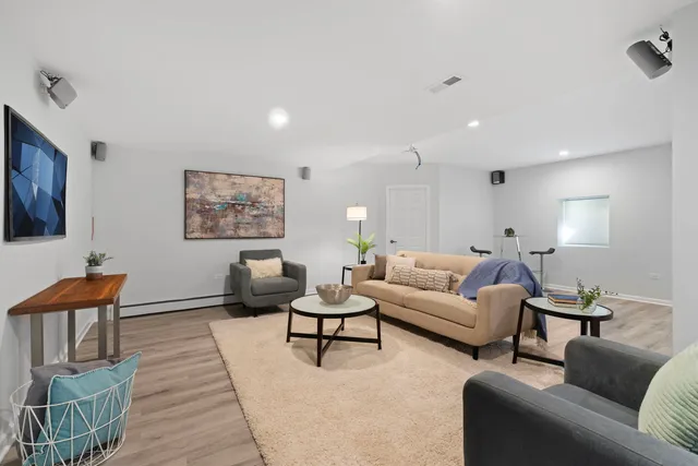 a living room with furniture and a lamp