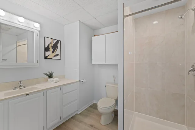 a view of bathroom with a toilet sink and mirror