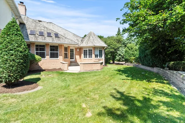 a view of a house with a yard and sitting area
