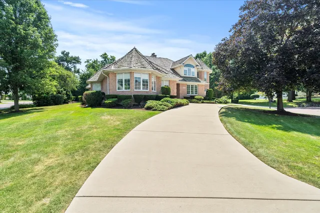 an aerial view of a house with a yard