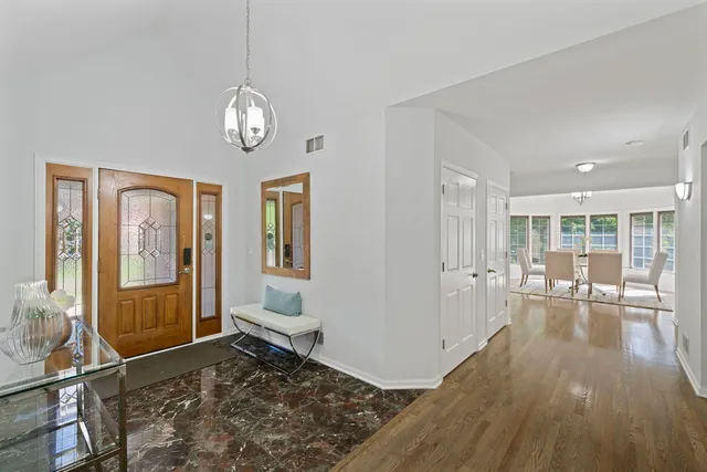 a view of a livingroom with wooden floor and large window
