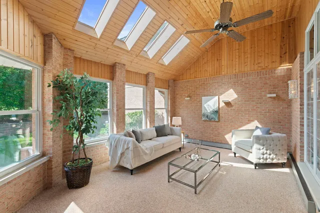 a living room with furniture and a floor to ceiling window