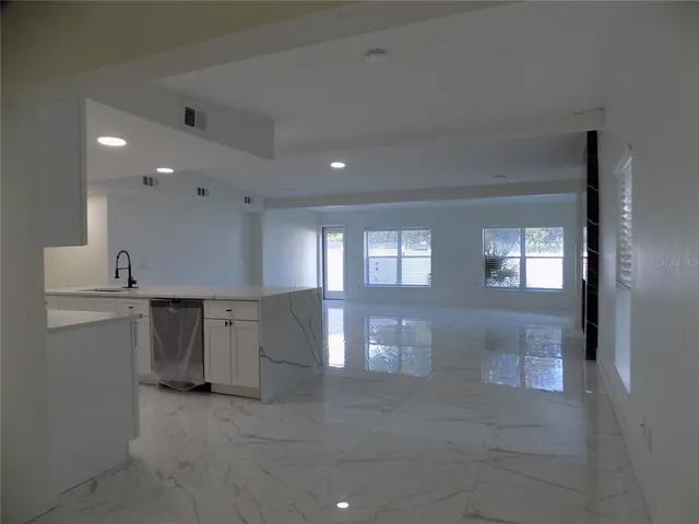 a view of a hallway with a kitchen