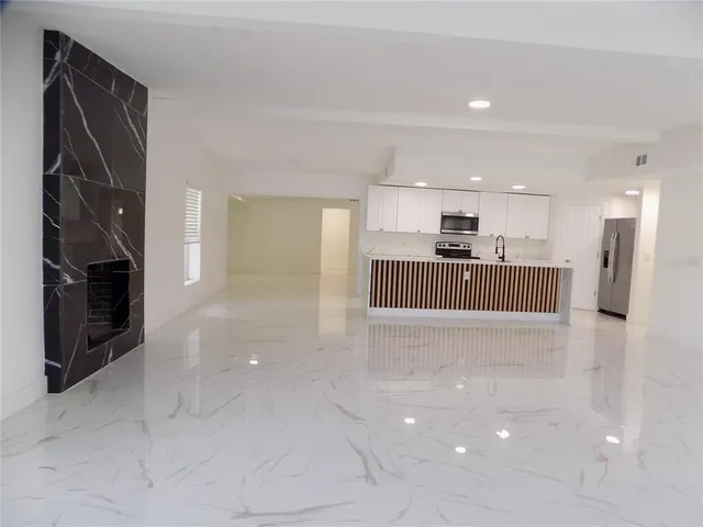 a view of kitchen and refrigerator