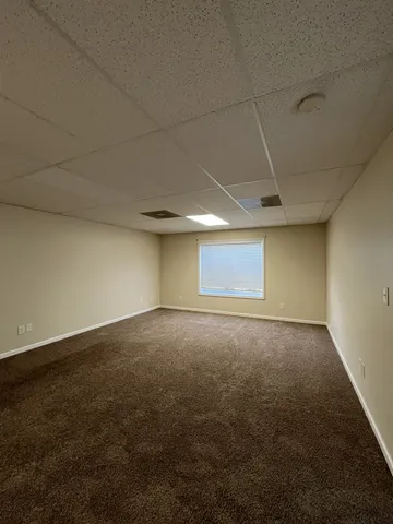 an empty room with a empty space and windows