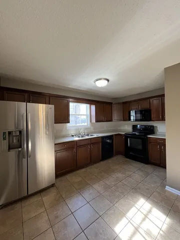 a large kitchen with a large counter top appliances and cabinets