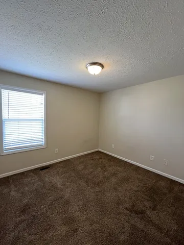 an empty room with a empty space and windows