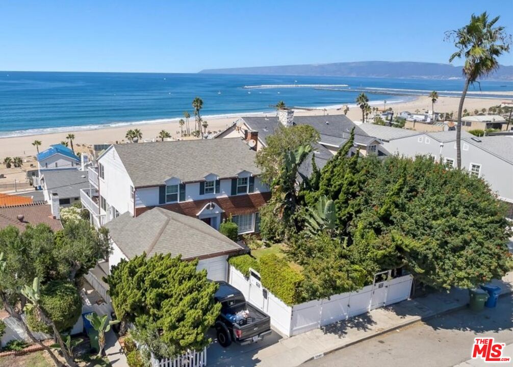an aerial view of a house with a yard and lake view
