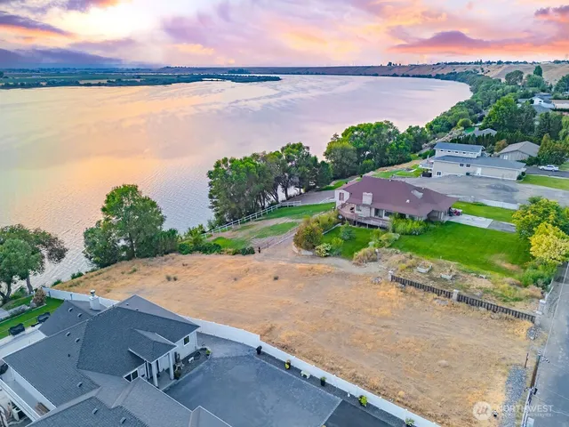 an aerial view of a house with a garden and lake view