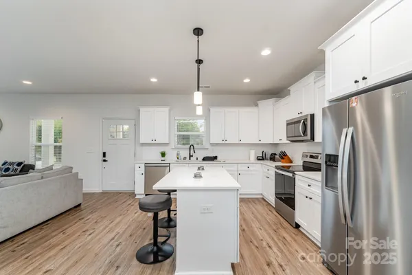 a kitchen with a sink appliances and cabinets