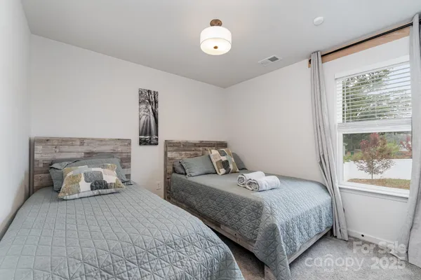 a bedroom with a bed and a large window