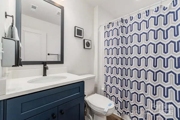 a bathroom with a sink a toilet and a mirror