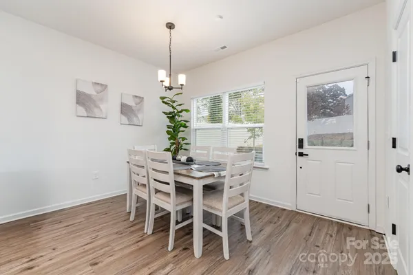 a view of a dining room with furniture wooden floor and chandelier