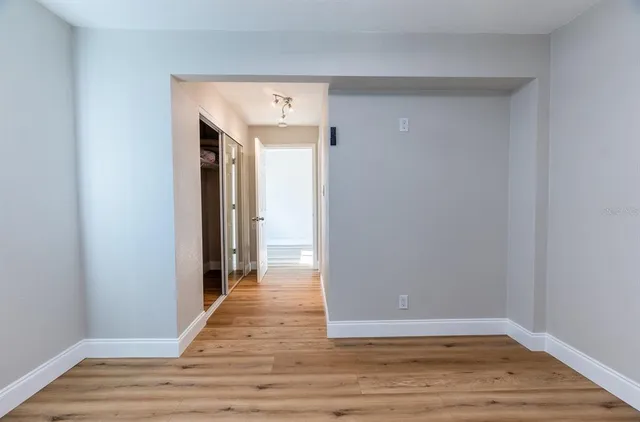a view of a hallway with wooden floor