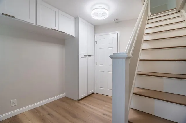 a view of an empty room with wooden floor and entryway
