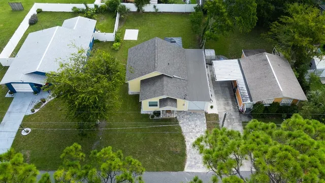 an aerial view of a house with a yard