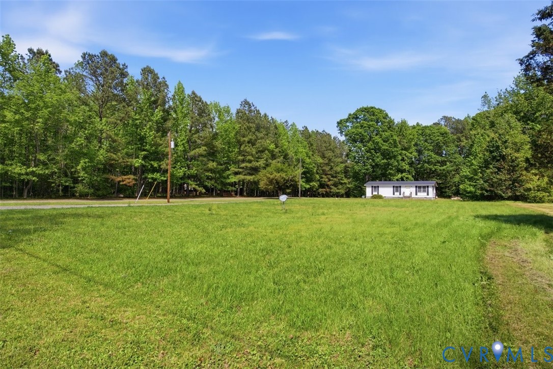 14527 Arwood Road Disputanta, VA 23842 - Photo 4 of 20 a view of a green field with wooden fence
