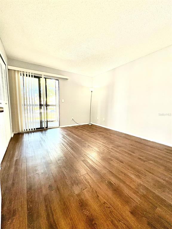 2102 Cascades Boulevard, Unit 205 Kissimmee, FL 34741 - Photo 11 of 12 a view of empty room with wooden floor and fan
