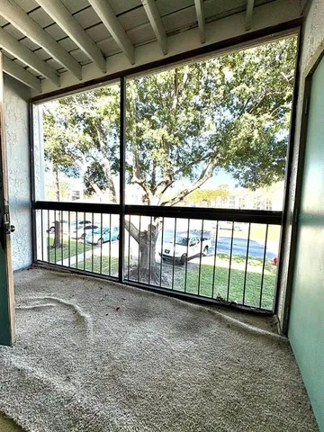 a view of a porch with a floor to ceiling window