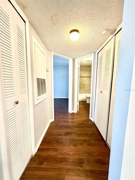 2102 Cascades Boulevard, Unit 205 Kissimmee, FL 34741 - Photo 9 of 12 a view of a hallway with wooden floor and staircase