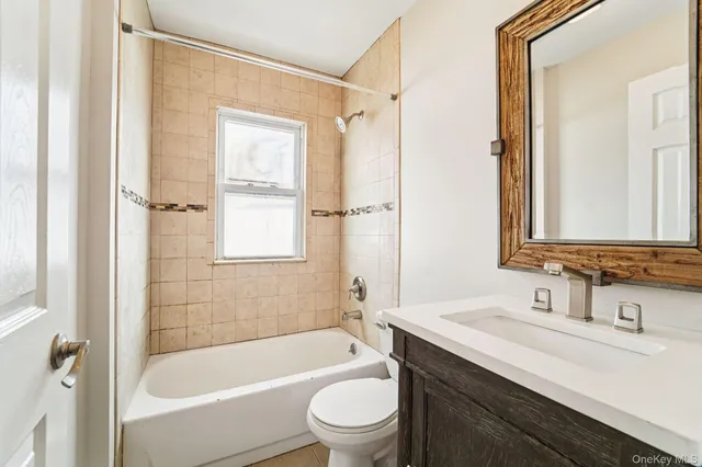an empty room with wooden floor chandelier fan and windows