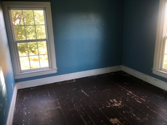 6802 North Quarry Road Warren, IL 61087 - Photo 16 of 21 an empty room with wooden floor and windows