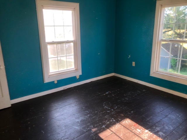 6802 North Quarry Road Warren, IL 61087 - Photo 17 of 21 an empty room with wooden floor and windows