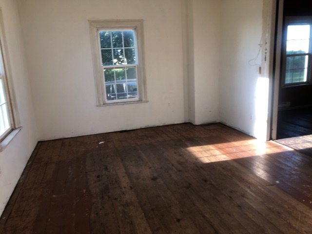 6802 North Quarry Road Warren, IL 61087 - Photo 3 of 21 an empty room with wooden floor and windows