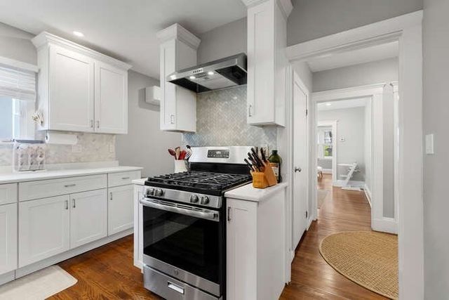 a kitchen with stainless steel appliances granite countertop a stove and a sink