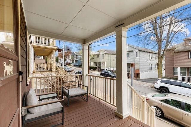 a view of a patio with furniture and wooden floor