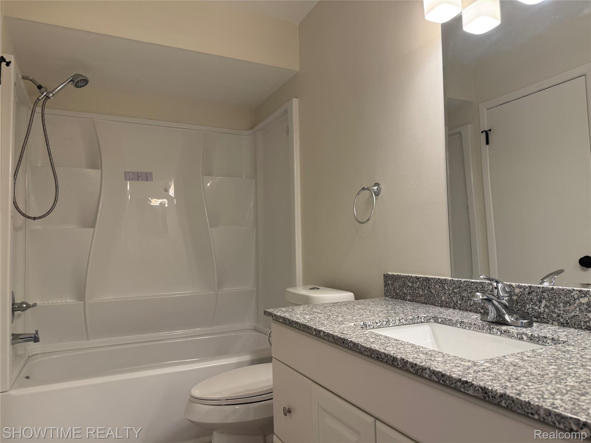 29141 Hayes Road Warren, MI 48088 - Photo 13 of 18 White tub and shower combination with a handheld showerhead