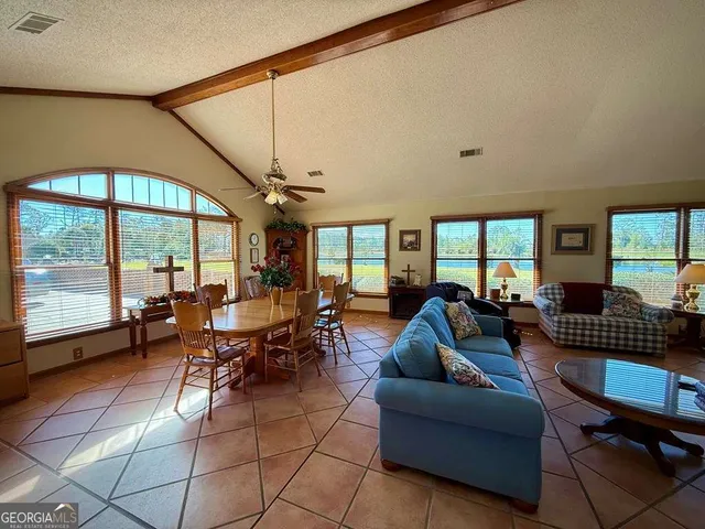 a spacious bathroom with a double vanity sink a large mirror and a bathtub
