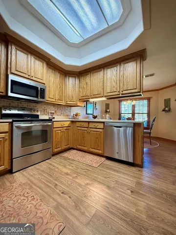 a spacious bathroom with a sink mirror and toilet