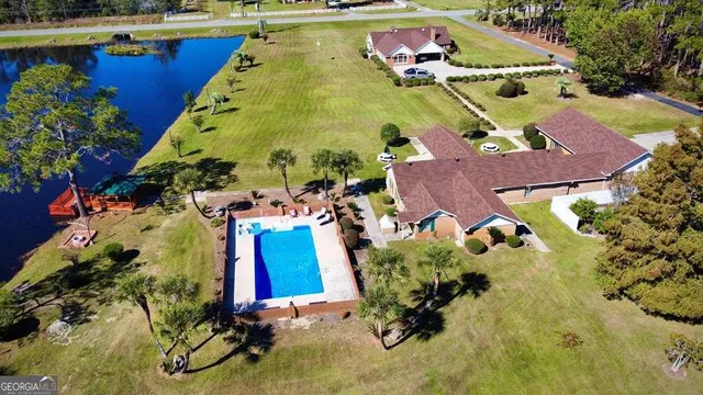 an aerial view of a house with a swimming pool and outdoor space