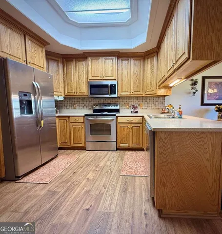 a view of a house with swimming pool and sitting area