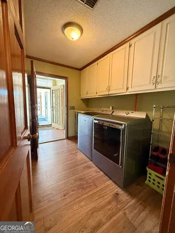 a bedroom with a bed lamp and dresser