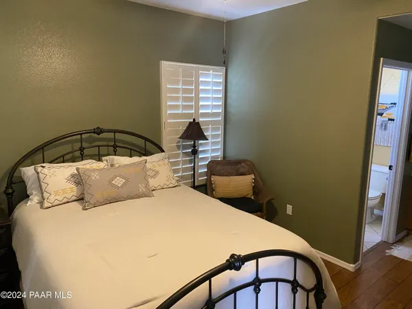 a bed sitting in a bedroom next to a window