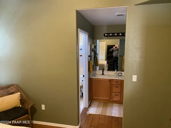 a bathroom with a granite countertop shower and a toilet