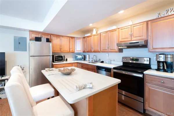 a kitchen with a stove a refrigerator and a sink