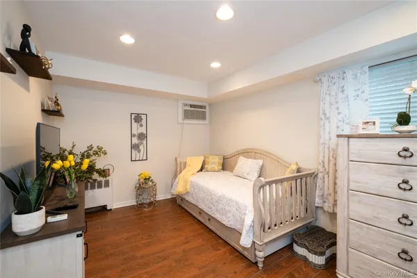 a bedroom with a bed and a potted plant
