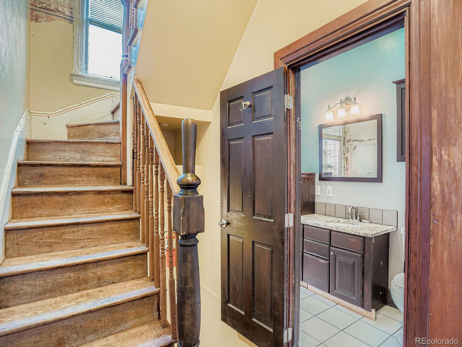 2516 North Marion Street Denver, CO 80205 - Photo 14 of 31 a view of front door with stairs and a vanity