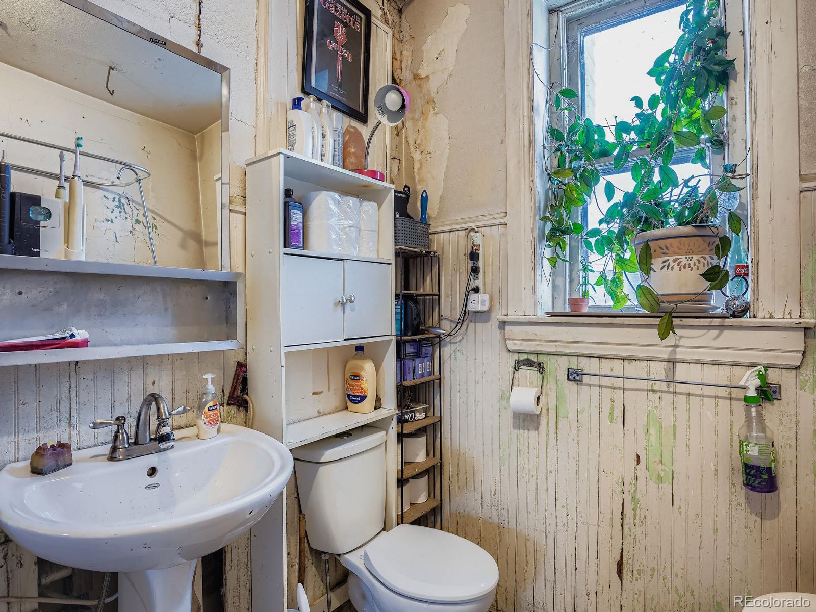 2516 North Marion Street Denver, CO 80205 - Photo 18 of 31 a bathroom with a sink a toilet and mirror