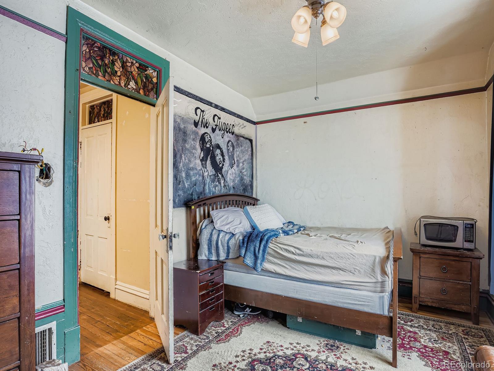 2516 North Marion Street Denver, CO 80205 - Photo 20 of 31 a bedroom with a bed and a chandelier