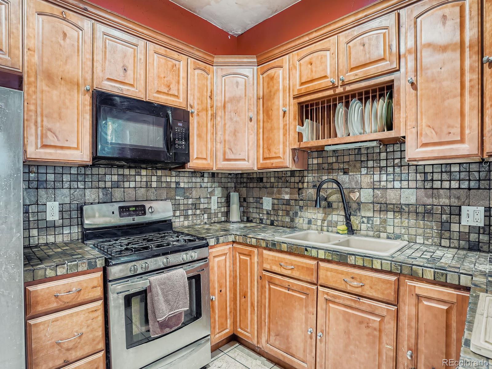 2516 North Marion Street Denver, CO 80205 - Photo 4 of 31 a kitchen with stainless steel appliances granite countertop a sink stove and cabinets
