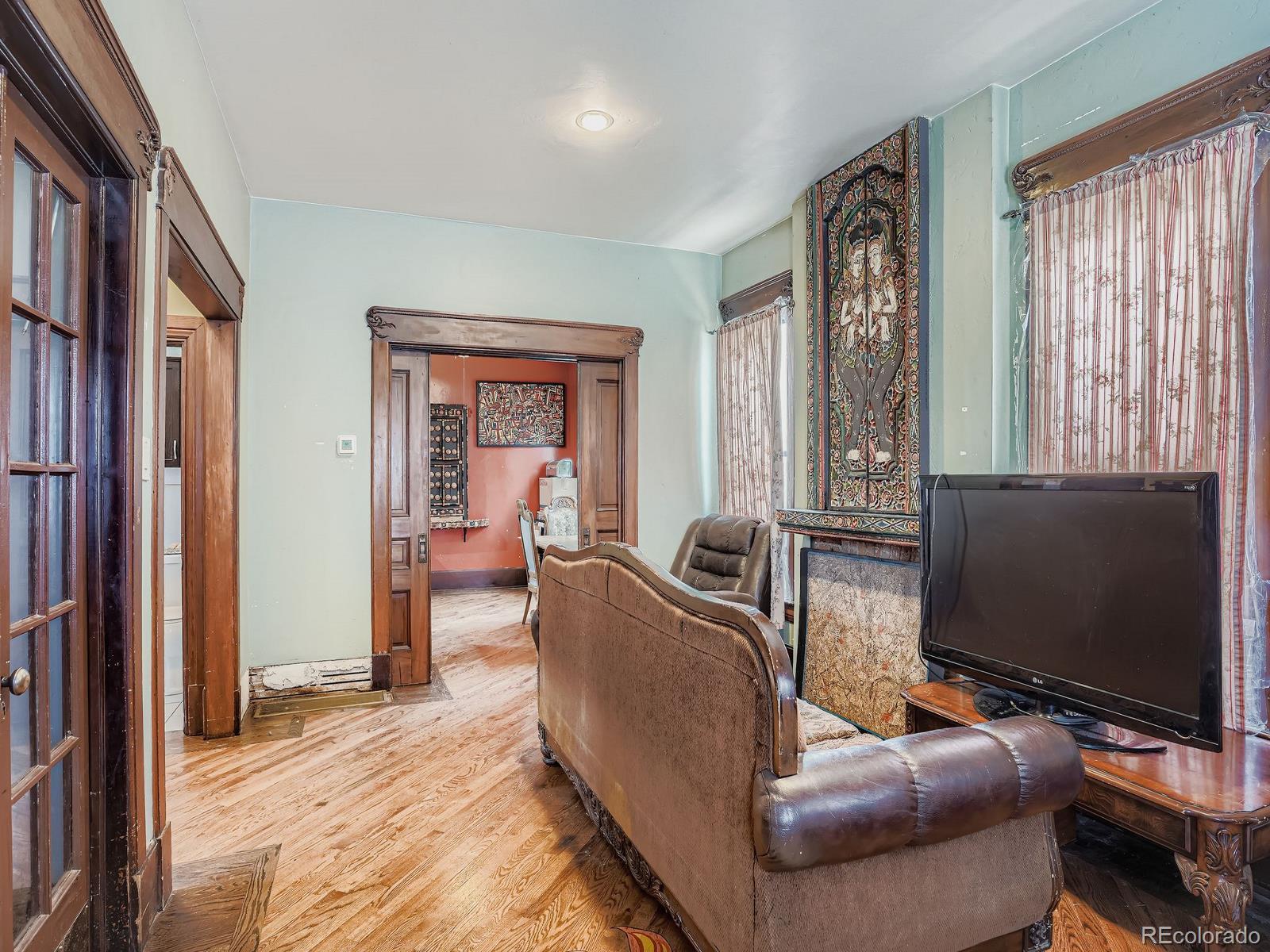 2516 North Marion Street Denver, CO 80205 - Photo 7 of 31 a living room with furniture and a flat screen tv