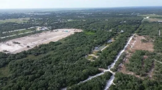 an aerial view of residential house with green space
