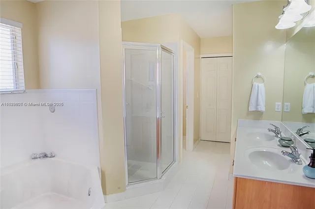 a view of staircase with railing and a chandelier