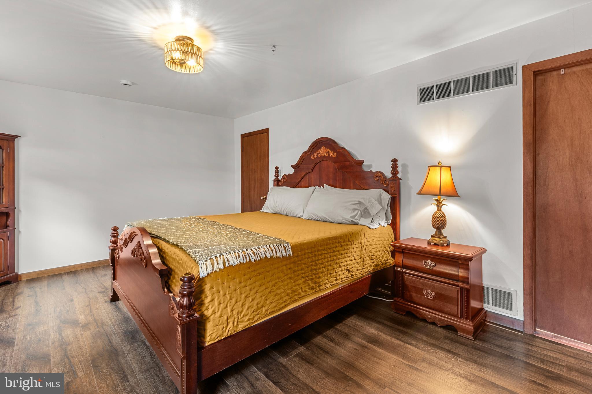 1003 Jackson Hall School Road Elkton, MD 21921 - Photo 26 of 49 a bedroom with a bed and wooden floor