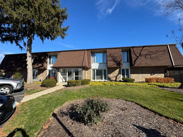 a view of a house with backyard and sitting area