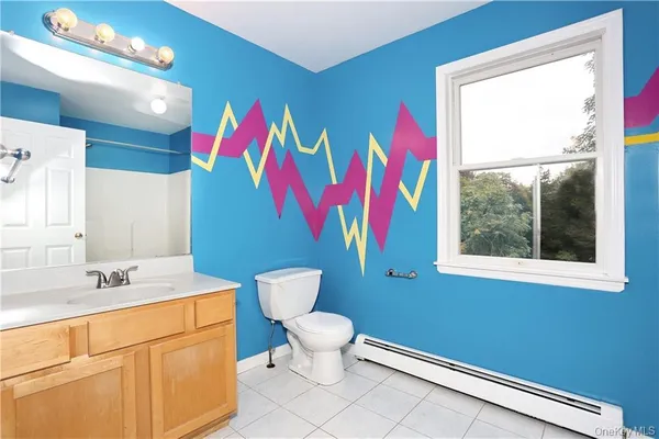 a bathroom with a sink a toilet and a window